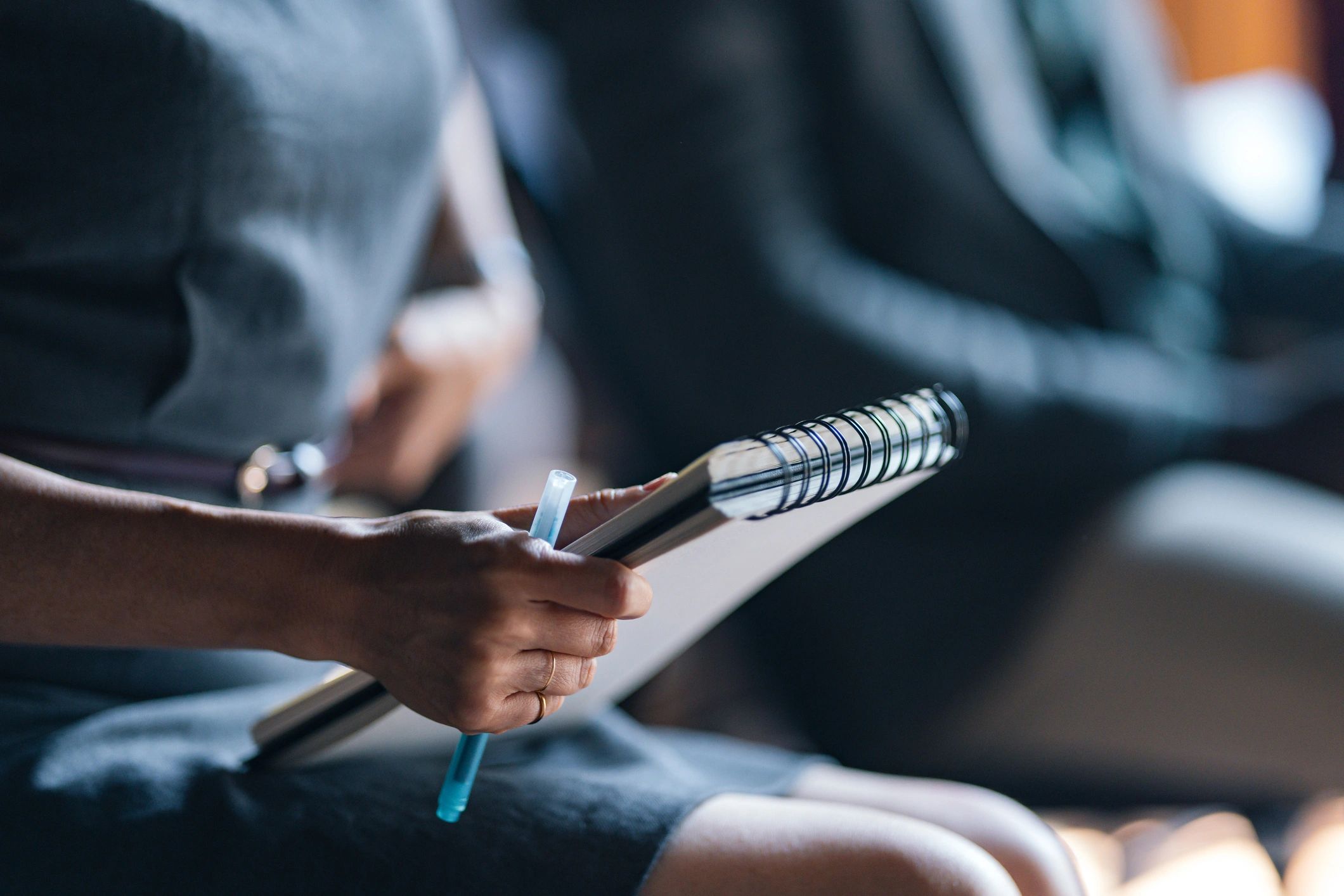 Attendee taking notes in a workshop