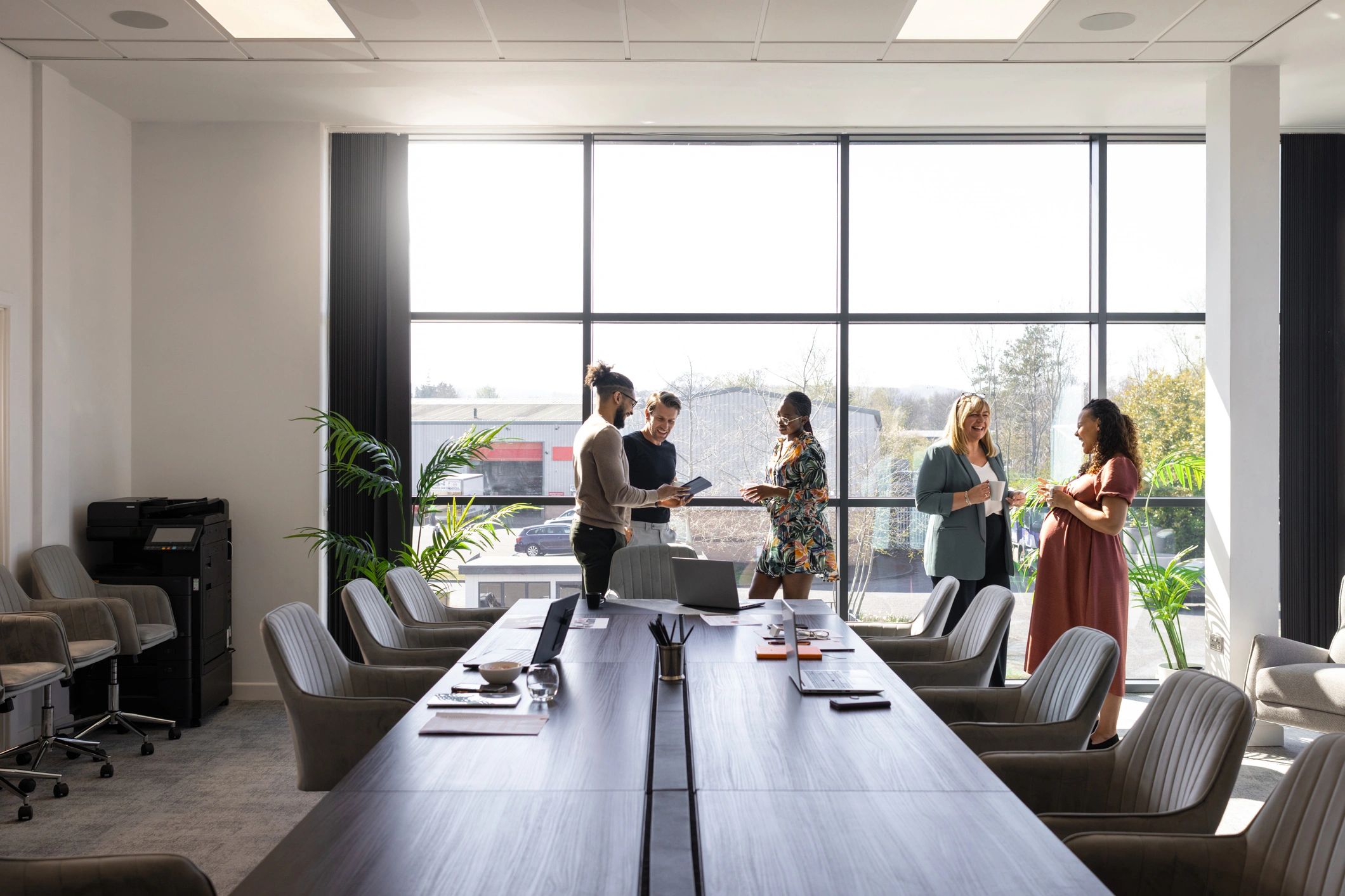 Women and colleagues talking during a conference break in a bright meeting room