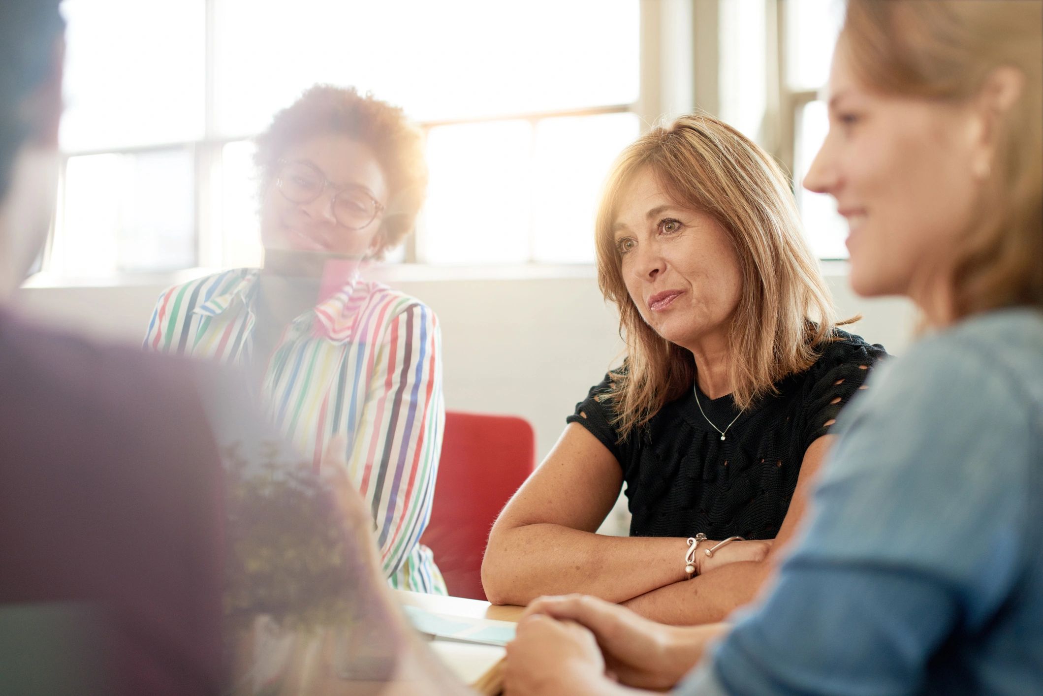 Women collaborating in a small group discussion